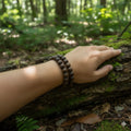person wearing bracelet made from 10 mm black oak wood beads