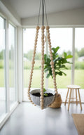 Hanging plant holder decorated with turned wooden beads